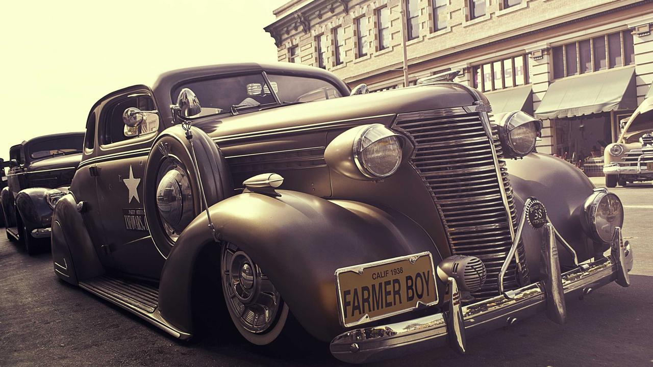 A sleek sidewalk delivery robot navigating a modern city