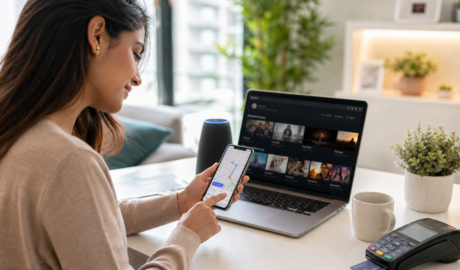 Person using smartphone and laptop with AI-powered navigation, streaming, and digital payments